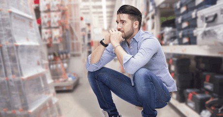 a man inside a hardware store undecided on buying a pair or ramps