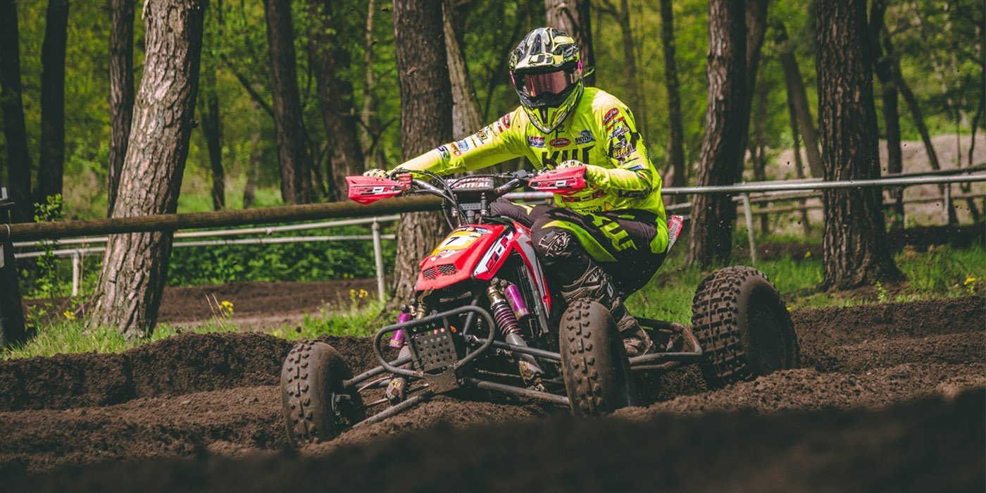 a person riding an atv in the woods