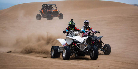 two person riding ATV on a desert