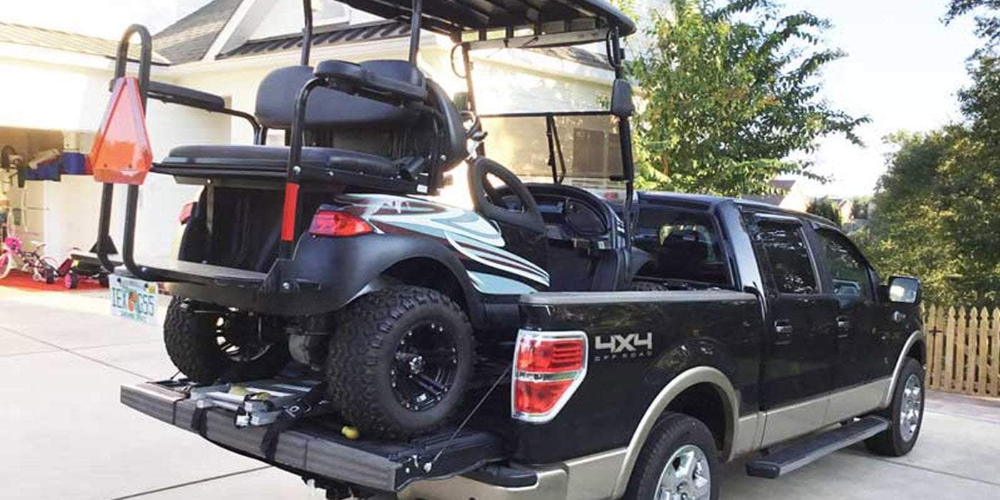 golf cart loaded on black ute