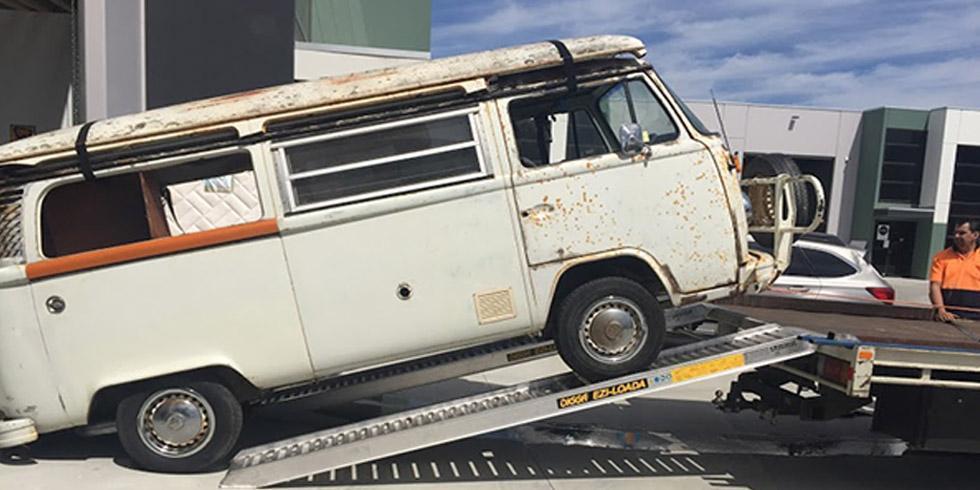 a van loading a truck trailer on a ramp