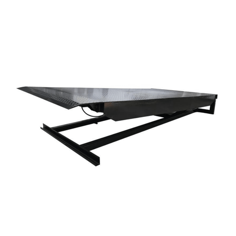 A heavy-duty black steel dock leveler with a diamond-plate surface, used to bridge the gap between a dock and a truck.