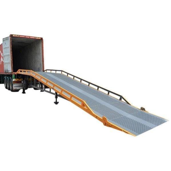 Yellow and grey steel yard ramp against a truck trailer