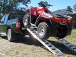 ATV driven up a pair of Sureweld rigid one-piece aluminium loading ramps onto a ute tray