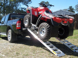 ATV driven up a pair of Sureweld rigid one-piece aluminium loading ramps onto a ute tray