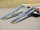 Pair of Sureweld Rubber Series aluminium loading ramps hooked onto the back of a ute tray