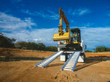 Excavator driven up a pair of Sureweld Track Series aluminium loading ramps onto a tipper truck