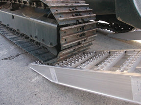 Steel-tracked excavator on Digga Ezi-Loada Universal aluminium loading ramps