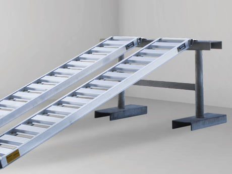 Close-up of a Sureweld rigid ATV ramp: one-piece side rails with open aluminium rungs, no fold joint
