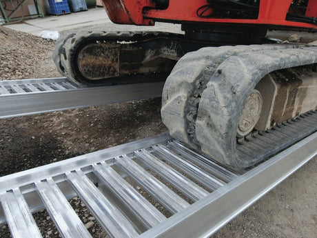 Rubber-tracked mini excavator climbing Digga Ezi-Loada standard aluminium loading ramps