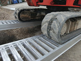 Rubber-tracked mini excavator climbing Digga Ezi-Loada standard aluminium loading ramps