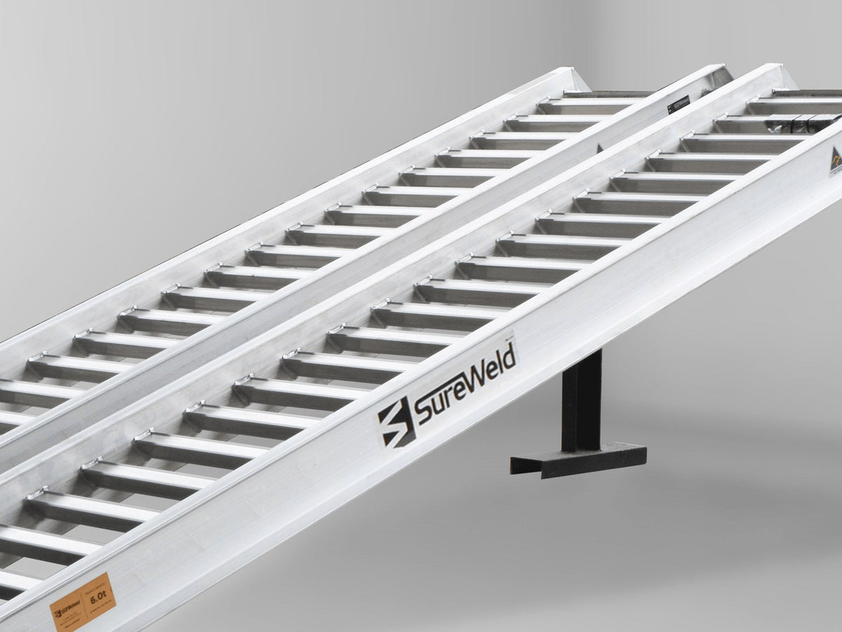Close-up of the rungs on a Sureweld PT Series ramp, shaped for rubber-track loaders