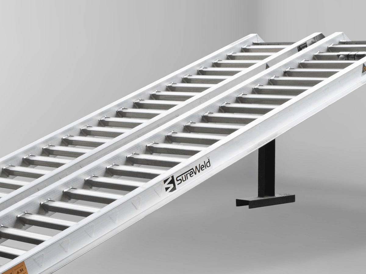 Close-up of the rungs on a Sureweld PT Series ramp, shaped for rubber-track loaders