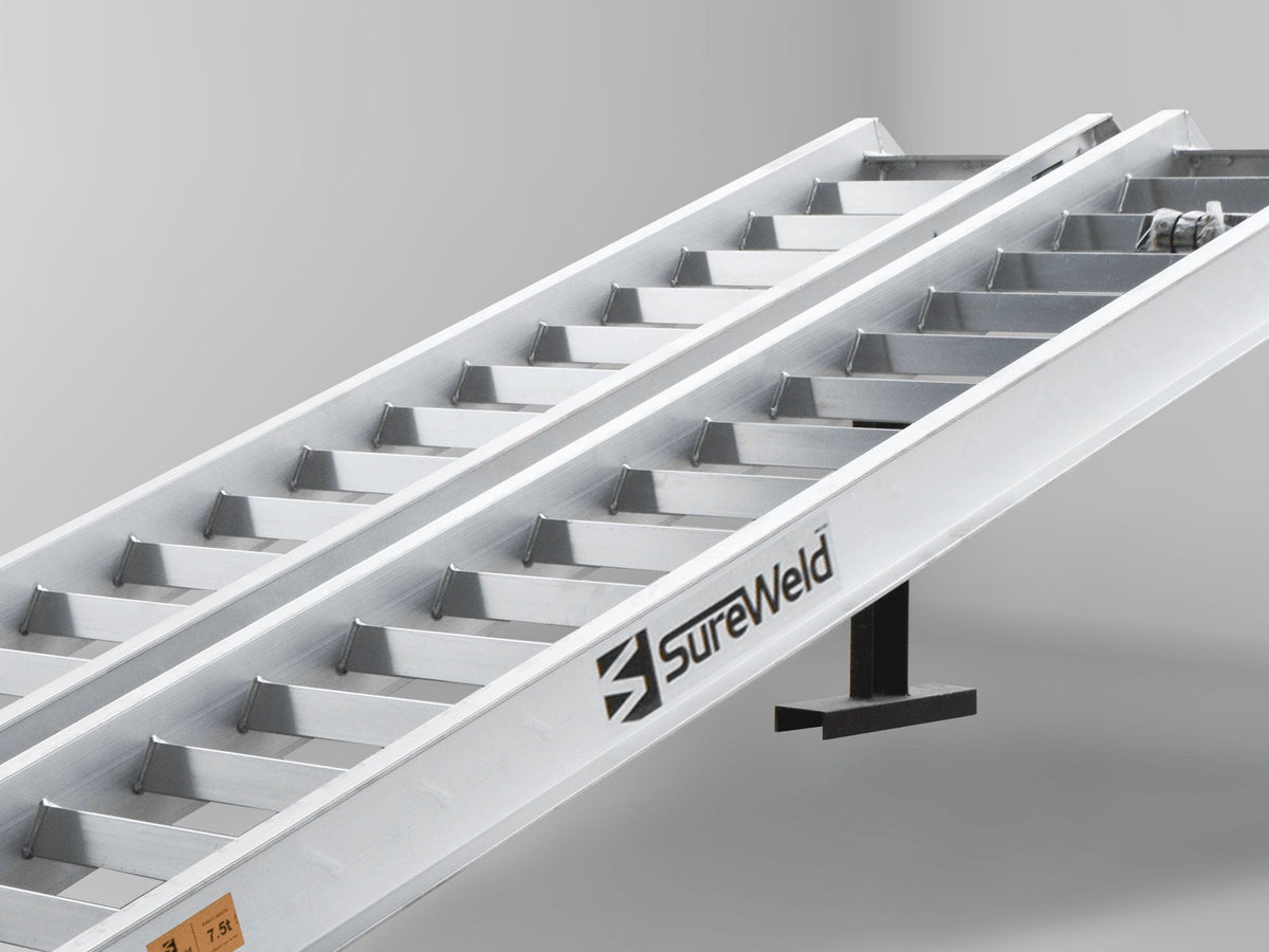 Close-up of the raised rungs on a Sureweld Track Series ramp, built for steel tracks