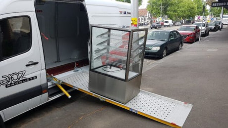 WM System Aluminium Easy Van Ramp, 300kg Capacity - trolley at the foot of the side-door ramp on a van