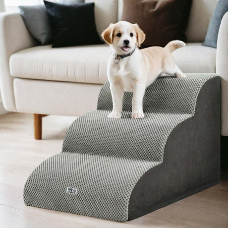 i.Pet 3-Step 30D Foam Dog Stairs with Washable Cover – Grey - puppy standing on the stairs beside a sofa