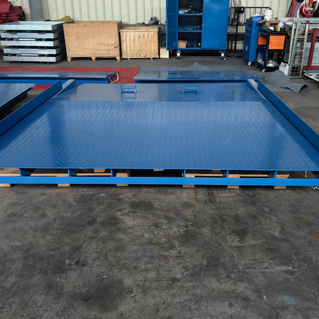 Warehouse setting with the dock plate installed on a loading bay, flush with the floor.