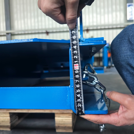 Close-up of a hand operating the spring-loaded locking mechanism on the side of the dock plate.