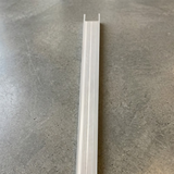 High-angle shot of a long, silver-anodized aluminium threshold ramp showing its ribbed, non-slip surface texture.