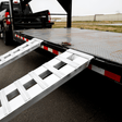 Gen-Y Hitch 4.5T 2.4m x 380mm Heavy Duty Aluminium Loading Ramps hooked on a gooseneck trailer deck