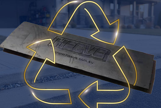 Metallic recycling sign with 'HEEVE' branding on a blurred background