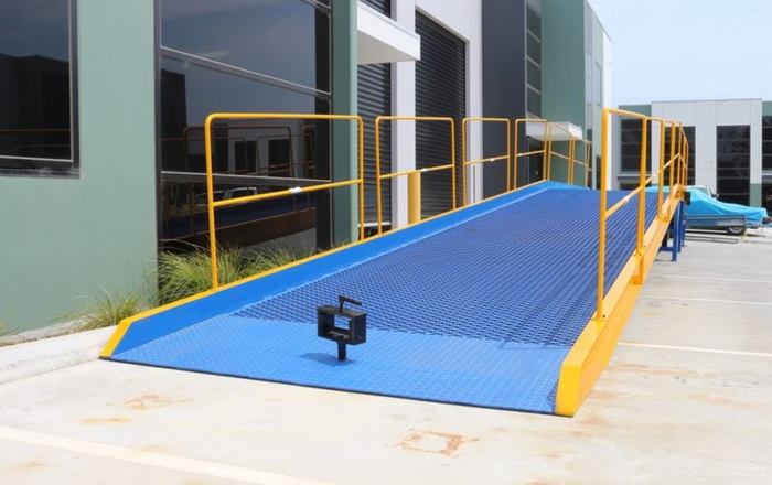 Blue and yellow steel forklift yard ramp at factory complex