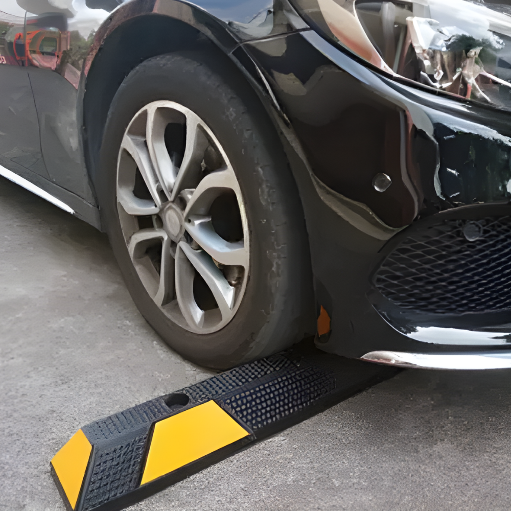 Car approaching a Base Guard® 1650mm Rubber Wheel Stop