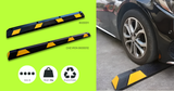 Set of Base Guard® 1830mm Rubber Wheel Stop with car wheel on a gray surface