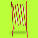 Red metal swing frame on a bright green background