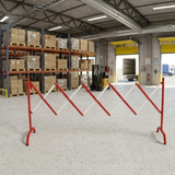 Warehouse interior with pallets, forklift, and red safety barriers.