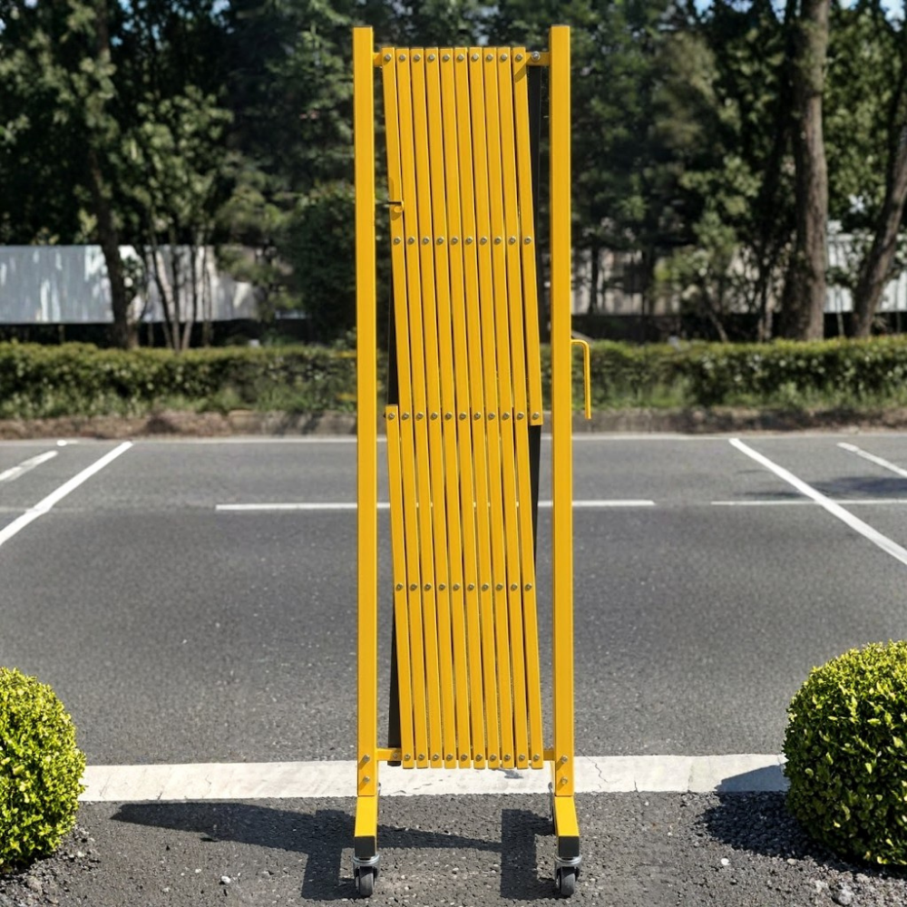Yellow metal barrier on a road with greenery in the background