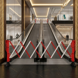 Escalator in a modern building with red and white barriers