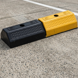 Base Guard® 500mm Rubber Wheel Stop on a concrete surface