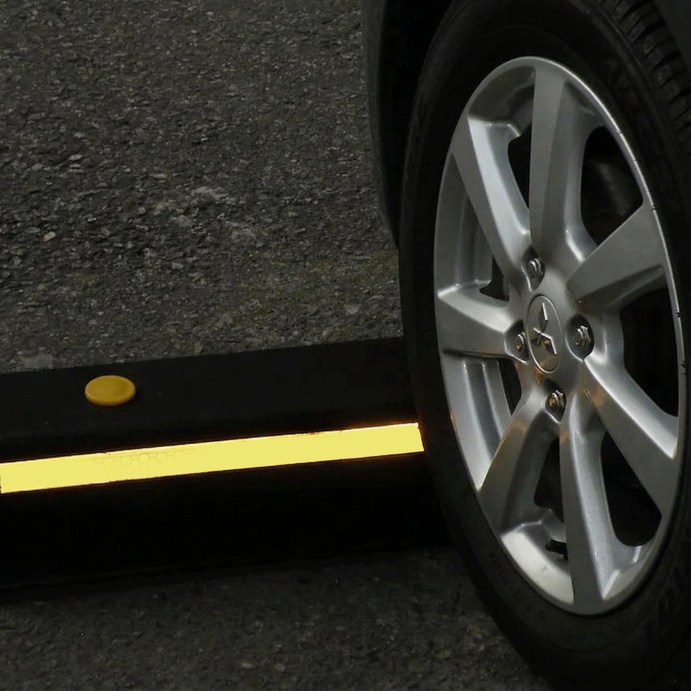 Car wheel approaching a speed bump on a road
