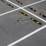 Gray pavement with Base Guard® 900mm Rubber Wheel Stop