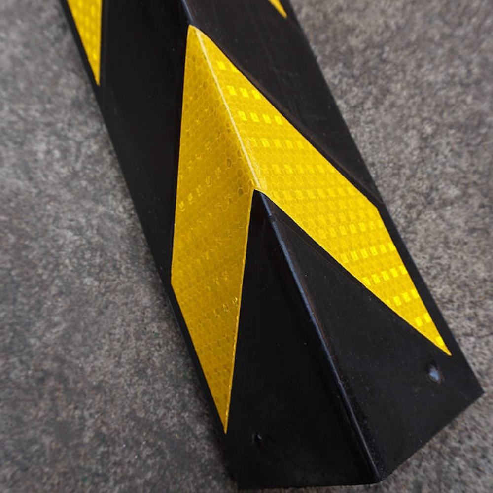 Zoomed in Base Guard Chevron Rubber Corner Guard – Heavy Duty on concrete