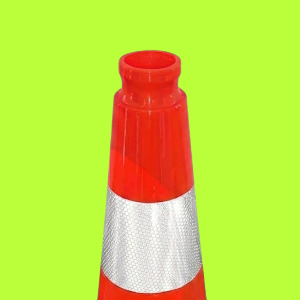 Red and silver traffic cone on a green background
