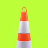 Traffic cone with red top and base on a green background