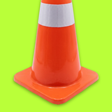 Orange traffic cone with a white reflective stripe on a green background