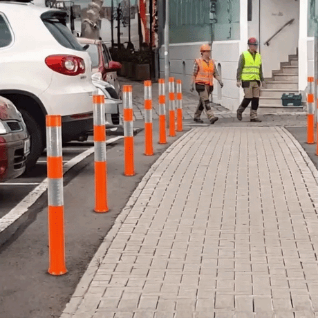 Reflective parking bollards lining a paved walkway with workers in high-vis gear, alongside four color options on the right.