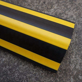Close up shot of Base Guard Stainless Steel Reinforced Rubber Corner Guard on concrete surface
