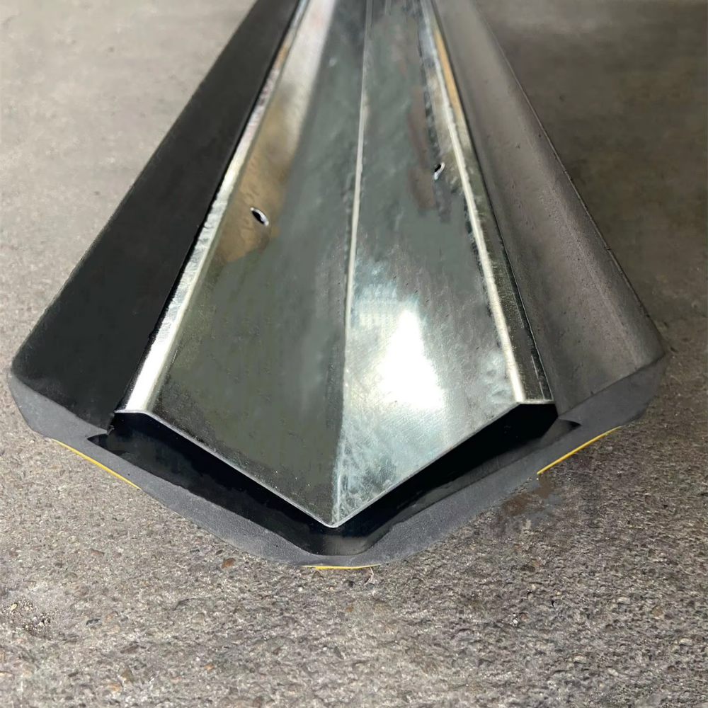 Close up shot of Base Guard Stainless Steel Reinforced Rubber Corner Guard on concrete surface