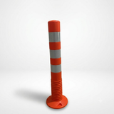 Orange traffic bollard with reflective stripes on a white background