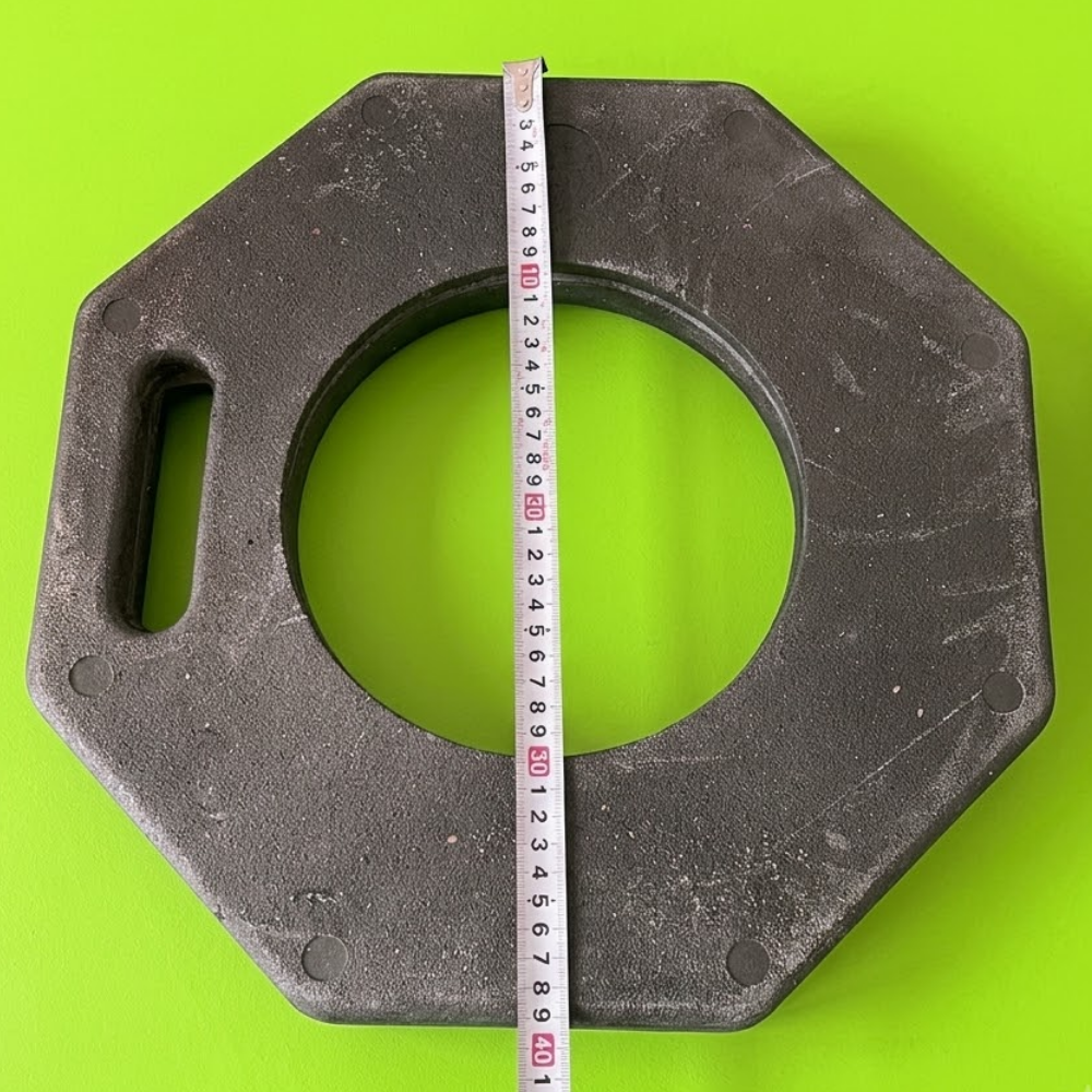 Hexagonal metal washer with a measuring tape on a green background