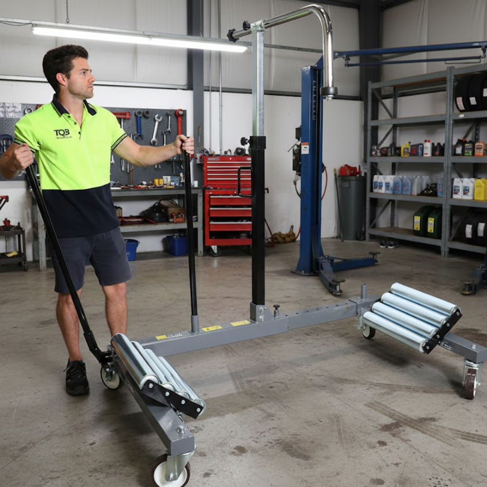 Staff in a workshop using the Borum Industrial Hydraulic Steel Wheel Dolly - 1200kg Capacity
