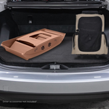 Car trunk with pet accessories including a brown pet bed and black pet seat.