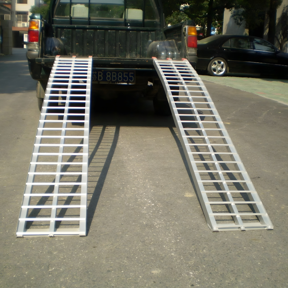 Heeve® 250kg 2.23m x 300mm Curved Non-Folding Aluminium Loading Ramp on a street with a vehicle in the background.