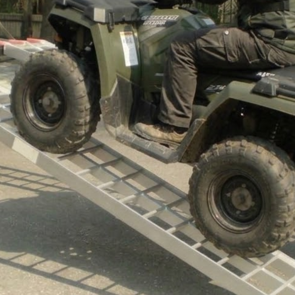 Person riding a green ATV on Heeve® 250kg 2.23m x 300mm Curved Non-Folding Aluminium Loading Ramp