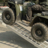 Person riding a green ATV on Heeve® 250kg 2.23m x 300mm Curved Non-Folding Aluminium Loading Ramp