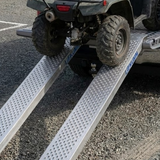 ATV being loaded onto a trailer with a ramp